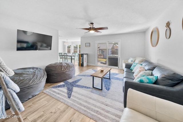 living room featuring hardwood / wood-style floors and ceiling fan