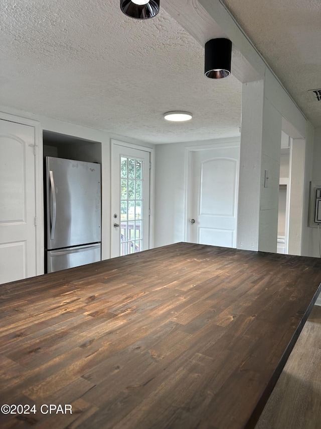 interior space with hardwood / wood-style flooring and a textured ceiling