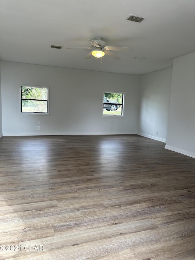 spare room featuring ceiling fan, a healthy amount of sunlight, and light hardwood / wood-style floors