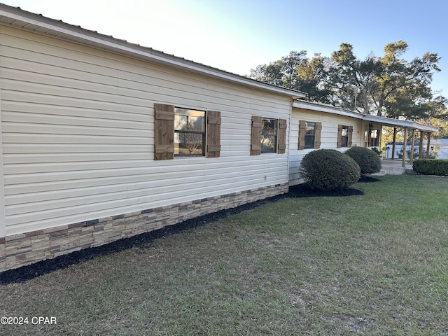 view of side of property with a lawn