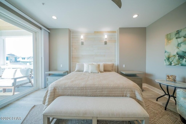 bedroom with access to outside and light hardwood / wood-style floors