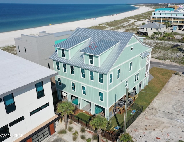 birds eye view of property featuring a water view and a beach view