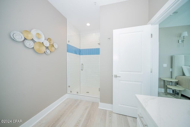 bathroom with vanity, wood-type flooring, and walk in shower