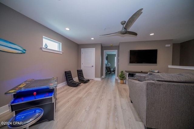 living room featuring light wood-type flooring and ceiling fan