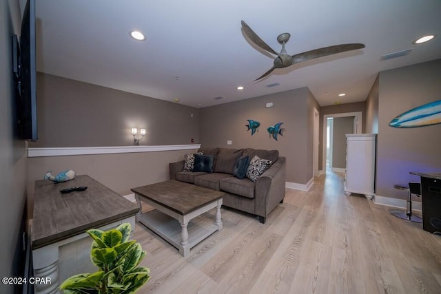 living room featuring light hardwood / wood-style flooring and ceiling fan