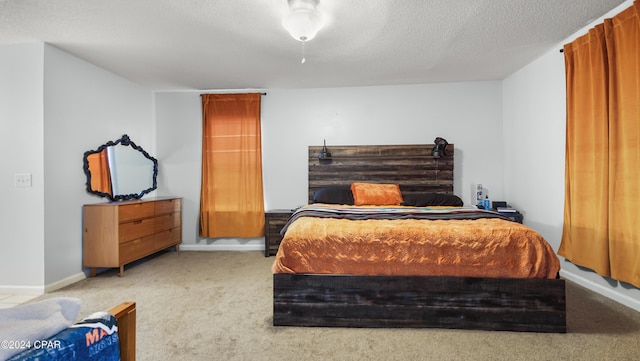 carpeted bedroom featuring a textured ceiling