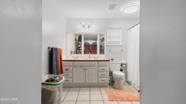 bathroom with vanity, tile patterned flooring, and a textured ceiling