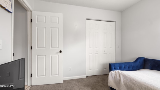 carpeted bedroom with a closet