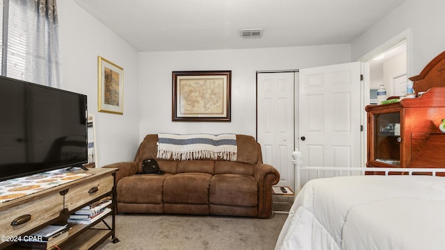 bedroom with light colored carpet and a closet