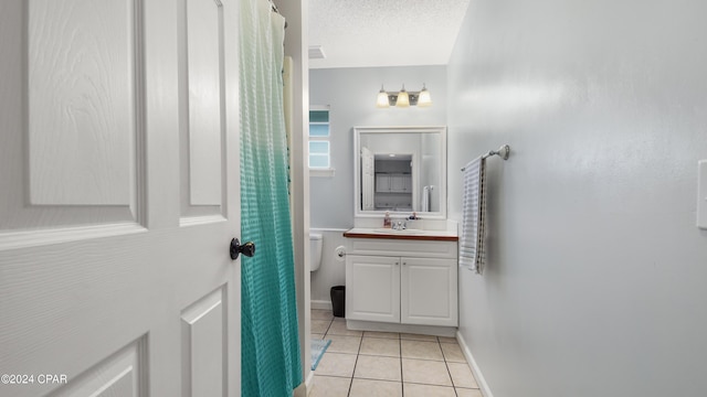 bathroom with vanity, tile patterned floors, a textured ceiling, and toilet