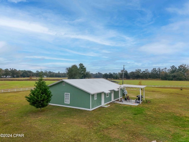 exterior space featuring a lawn and a rural view