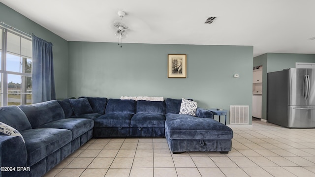 living room featuring light tile patterned floors and ceiling fan