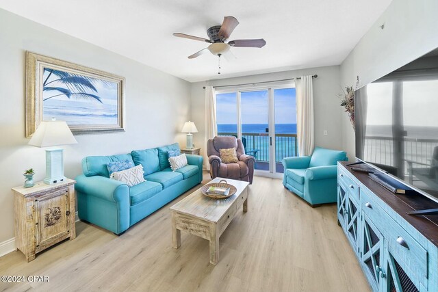 living area with light wood-style floors and ceiling fan