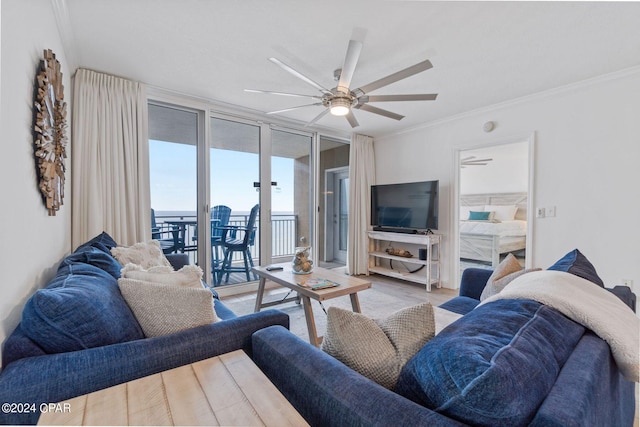 living room featuring ceiling fan, light hardwood / wood-style floors, and ornamental molding