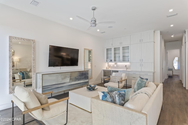 living room with ceiling fan, sink, and light hardwood / wood-style floors