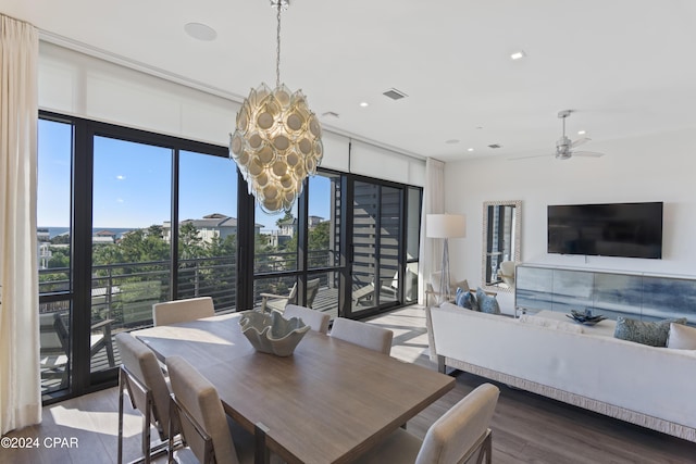 dining room featuring hardwood / wood-style floors and ceiling fan with notable chandelier