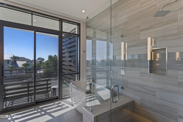 bathroom featuring a wall of windows and shower with separate bathtub