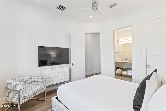 bedroom featuring hardwood / wood-style floors, ensuite bath, and ceiling fan