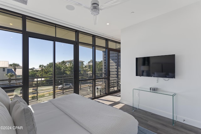 bedroom featuring floor to ceiling windows, ceiling fan, and hardwood / wood-style flooring