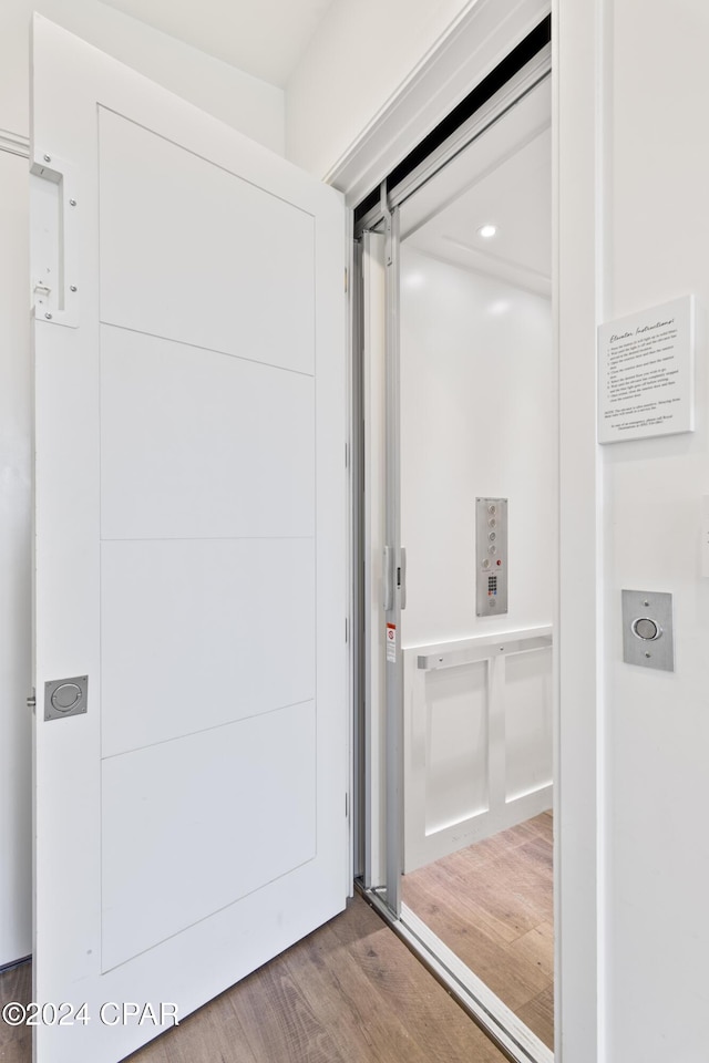 interior space featuring elevator and hardwood / wood-style floors