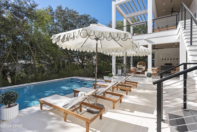 view of swimming pool with a patio area and ceiling fan