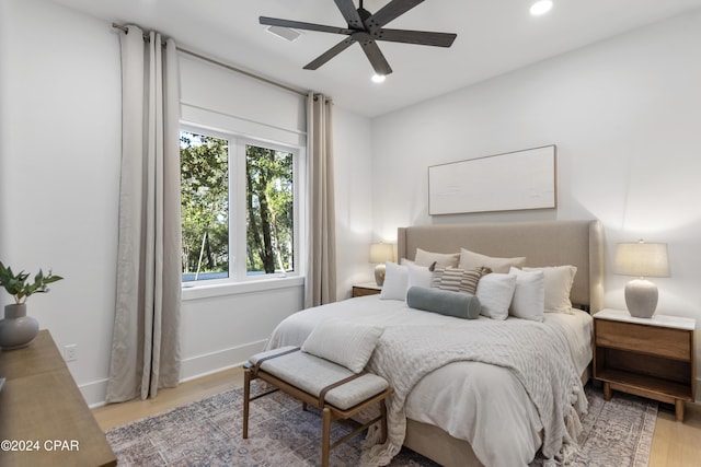 bedroom with ceiling fan and light hardwood / wood-style flooring