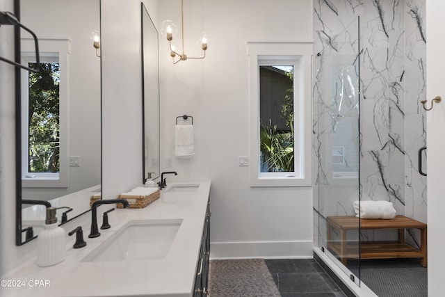 bathroom featuring a wealth of natural light, vanity, and a shower with shower door