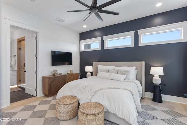 bedroom with connected bathroom, ceiling fan, and hardwood / wood-style floors