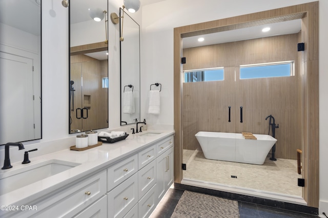 bathroom with tile patterned floors, vanity, and shower with separate bathtub