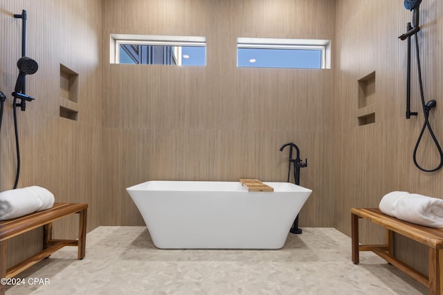 bathroom featuring a wealth of natural light and a washtub