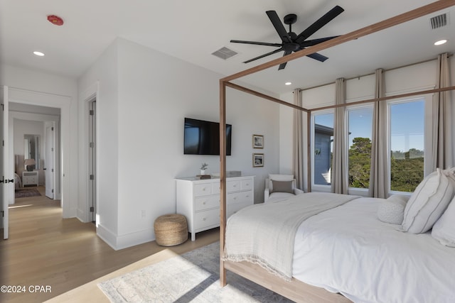 bedroom with ceiling fan and light wood-type flooring