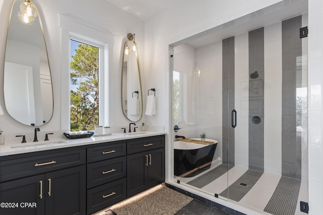 bathroom featuring vanity and shower with separate bathtub