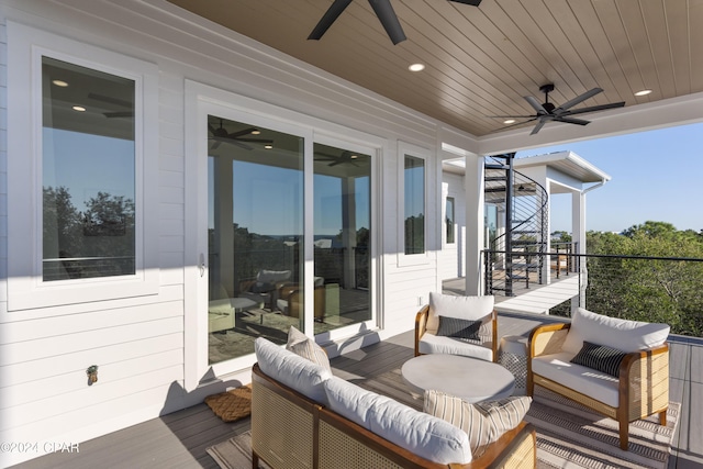 wooden terrace featuring outdoor lounge area and ceiling fan