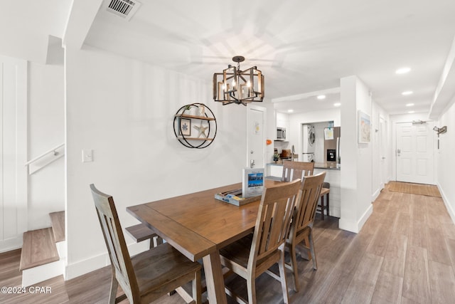 dining area featuring a notable chandelier and wood-type flooring