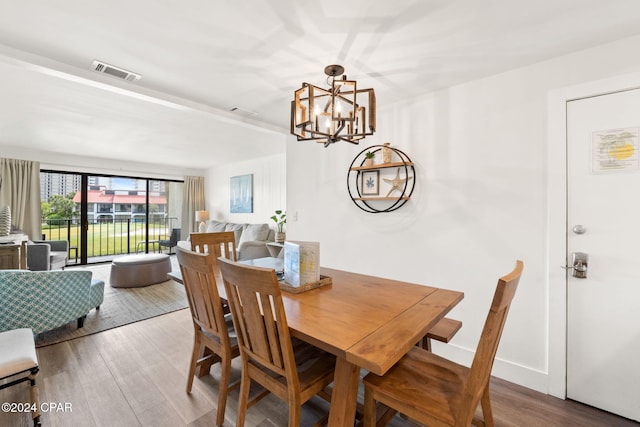 dining room featuring hardwood / wood-style flooring and a chandelier