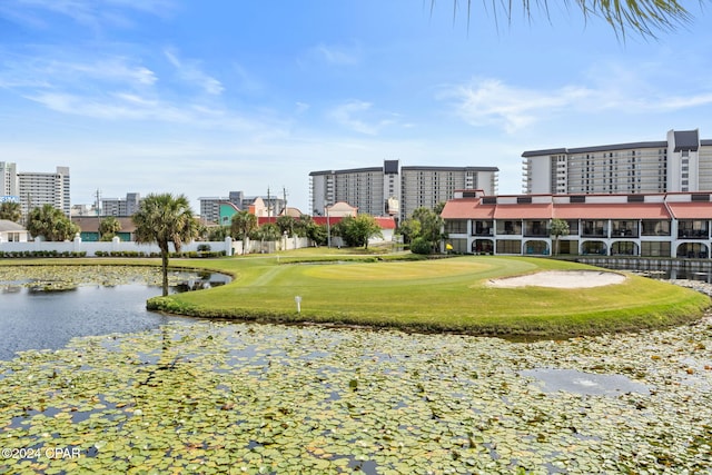 view of home's community with a yard and a water view