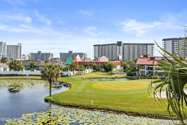 view of community featuring a water view and a yard