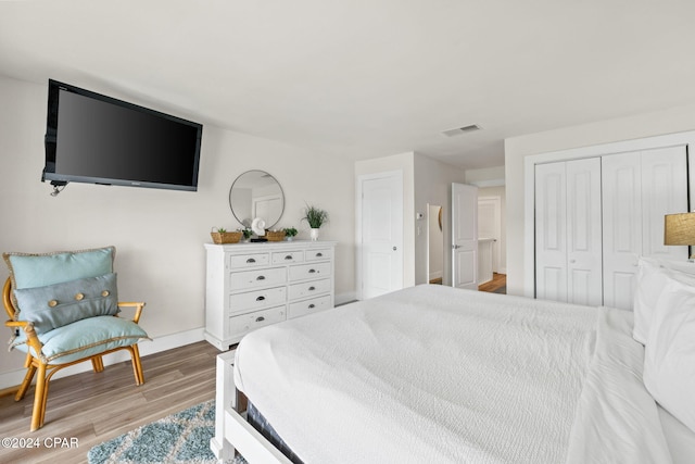 bedroom with light hardwood / wood-style flooring and a closet