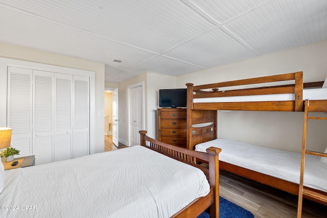 bedroom with hardwood / wood-style floors and a closet