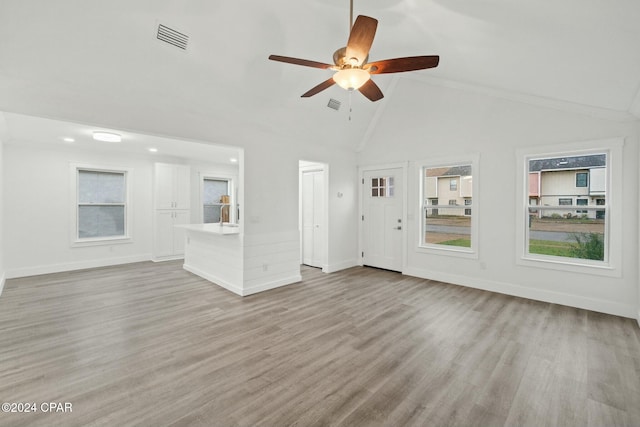 unfurnished living room with high vaulted ceiling, light hardwood / wood-style flooring, and ceiling fan