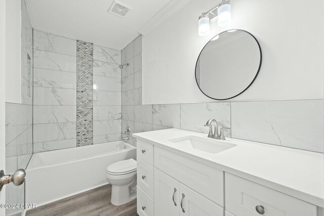 kitchen with sink, crown molding, a kitchen island with sink, appliances with stainless steel finishes, and white cabinets