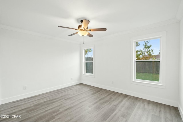 spare room with ceiling fan, ornamental molding, and a healthy amount of sunlight