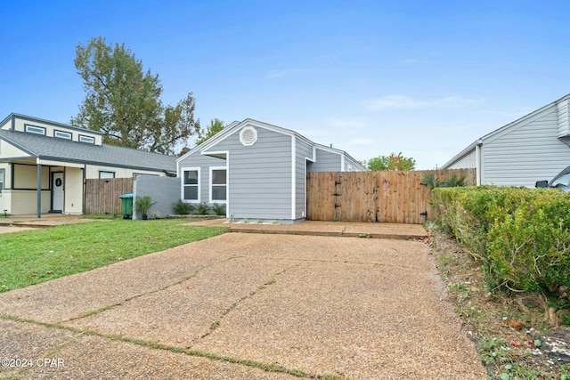 rear view of property with a lawn