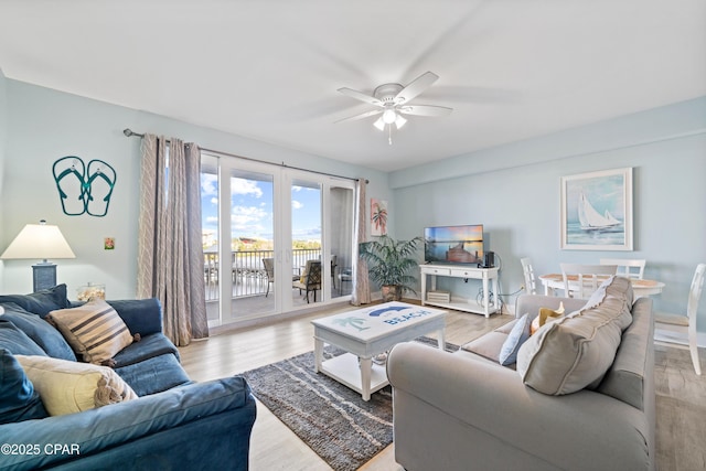 living room with french doors, light wood-type flooring, and ceiling fan