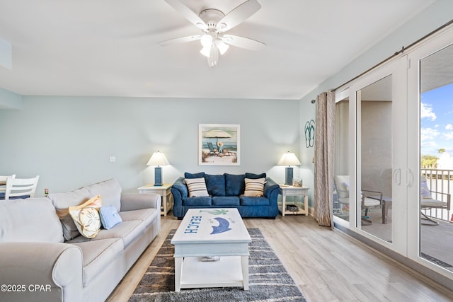 living room featuring ceiling fan, french doors, and light hardwood / wood-style flooring