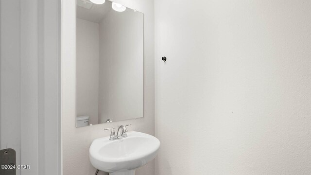 bathroom featuring wood-type flooring, vanity, and walk in shower