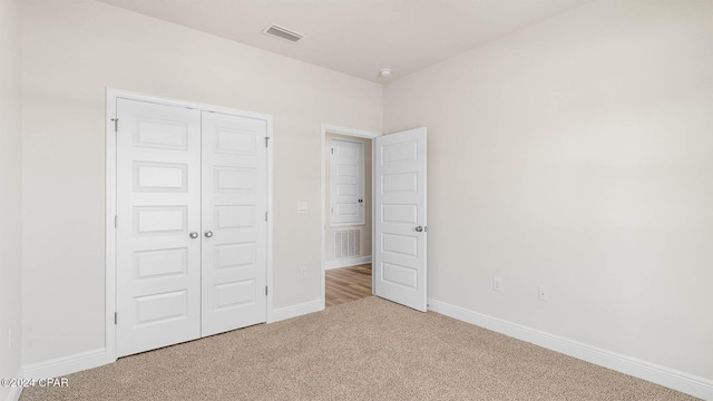 unfurnished bedroom with carpet floors and a closet