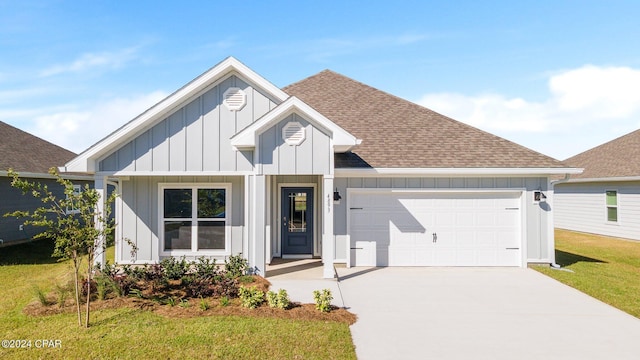 view of front of home with a front yard and a garage