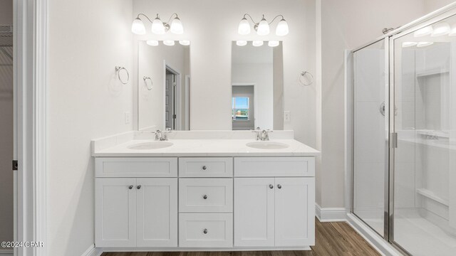 unfurnished bedroom with light carpet, ensuite bathroom, a raised ceiling, ceiling fan, and crown molding