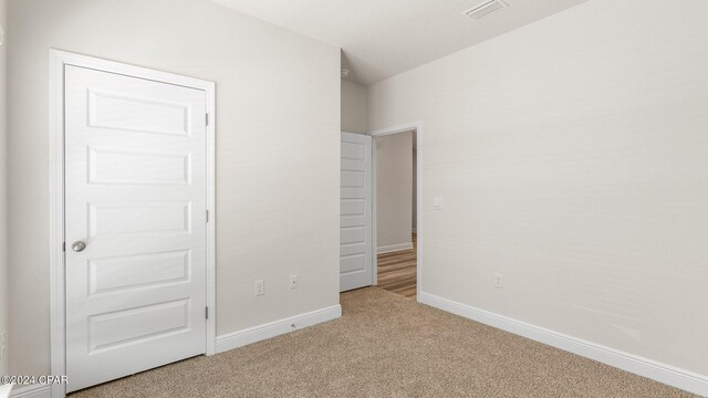 empty room featuring light carpet